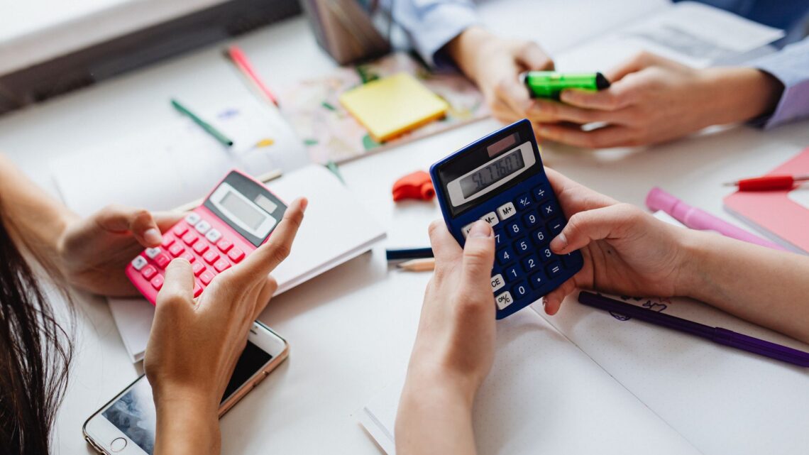 three kids solving using calculators