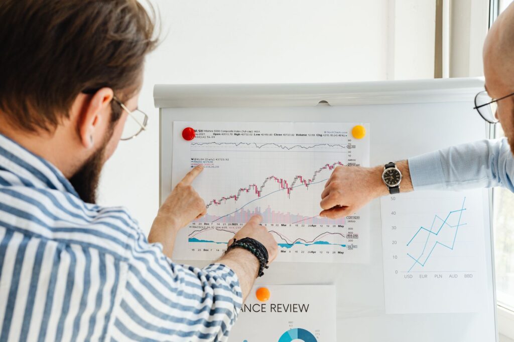 people looking at the graph on the board