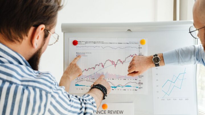 people looking at the graph on the board