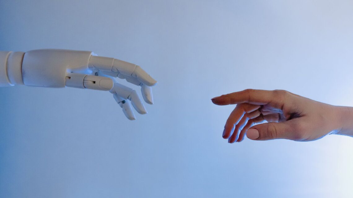 person reaching out to a robot
